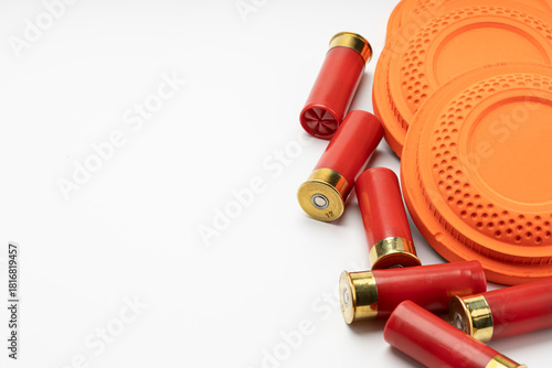 Clay disc flying targets and shotgun bullets on white background ,Clay Pigeon target