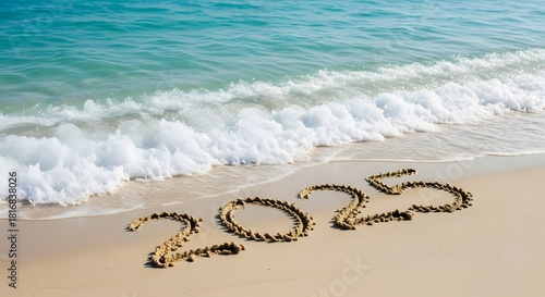 Fototapeta Naklejka Na Ścianę i Meble -  Welcoming 2025 new year s date written in sand at the beach