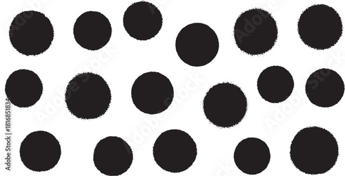 Black textured circles scattered on white background