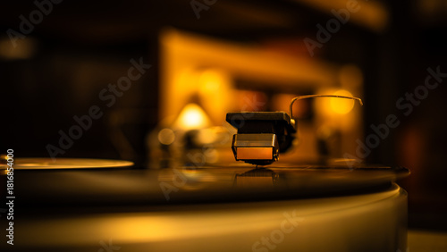 Close-up of spinning vinyl record on turntable, capturing motion of grooves and stylus. Classic analog music setup evokes nostalgia, creativity and warm sound