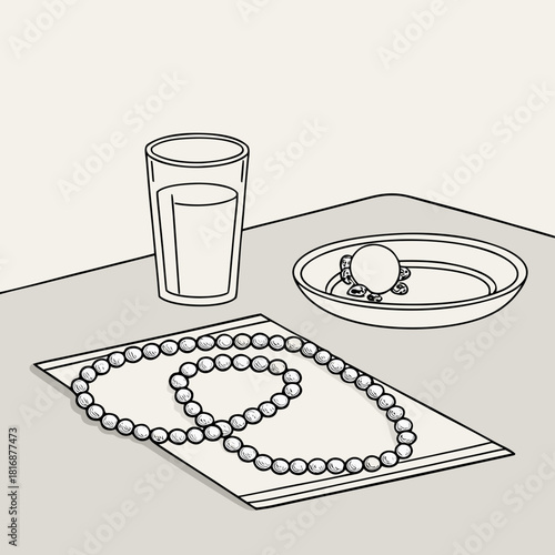 Still life of pearl necklace and ring with glass of water