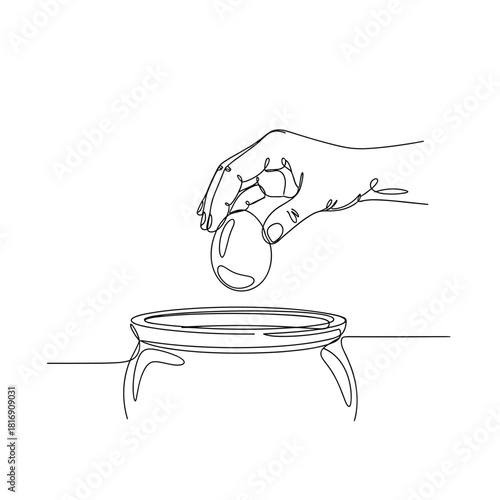 Hand dropping an egg onto a stand illustrating a science experiment or demonstration