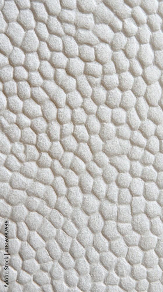 Naklejka premium Textured abstract background featuring a pattern of interlocking hexagons on a soft, light surface, perfect for showcasing modern design elements and minimalistic aesthetics.