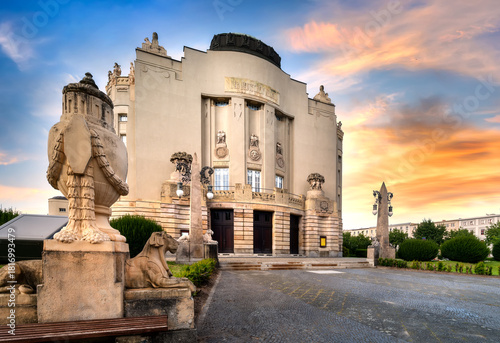 Art nouveau architecture of Cottbus Theater with sculptural details and lawn at sunset