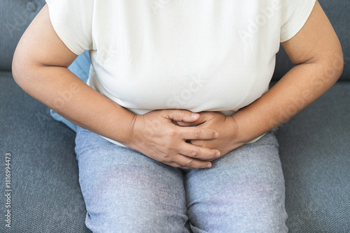 Sick asian senior woman in pain, hand holding belly, stomach pain from food poisoning, older hurt abdomen ache and digestive problem, gastritis or diarrhea. Health care inflammation, abdominal problem