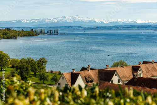 Lake Constance Bodensee in Germany near the city of Hagnau A series of Alpine mountains can be seen in the background photo was taken from the Birnau Church lot Houses, vineyards are visible