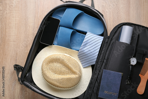 Open suitcase with male tra...