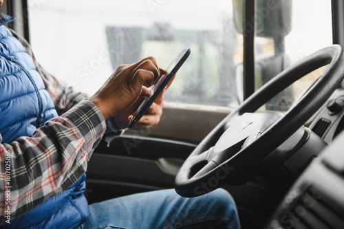 Konstfotografi Truck driver distracted by texting on smartphone