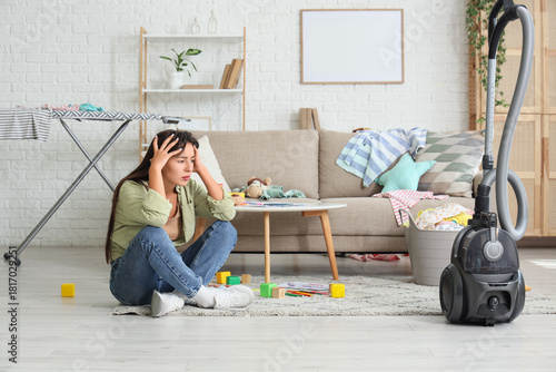Tired mother with scattered...