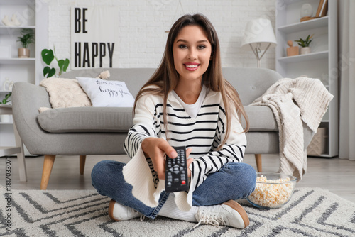 Young woman with remote con...