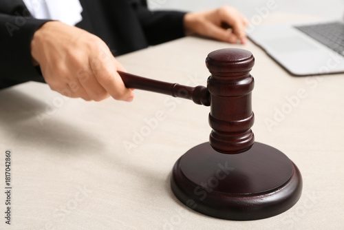 Judge's hand holding gavel ...