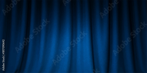 Blue velvet stage curtain backdrop illuminated by a theatrical spotlight, perfect for a show or cinema performance