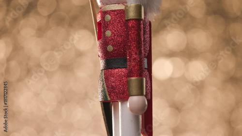 Toy Nutcracker spins gracefully against a vibrant golden bokeh background, ending with a close-up of its head