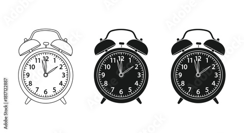 Three vintage alarm clocks showing different times in black and white