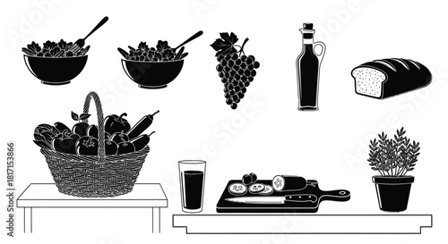 Still life arrangement of fruits bread wine and cheese in black and white
