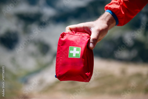 Man holding first aid kit in the mountain