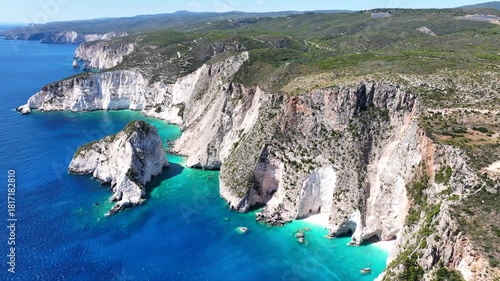 Aerial drone cinematic video of amazing seascape and bay of Plakaki featuring iconic white cliffs and sea caves visited by small boats and yachts, Zakinthos island, Ionian, Greece