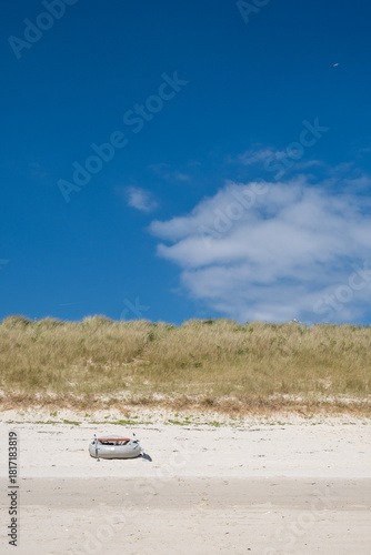 beach on tresco with boat Isles of Scilly 