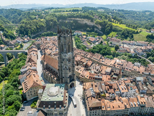 Aerial view of St Nicolas Cathedral in old town of Fribourg. Medieval church with large tower in Europe.