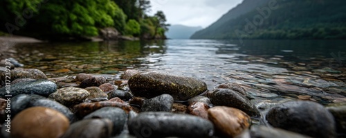 Scenic Lake View with Rocks and Lush Greenery on Shoreline.