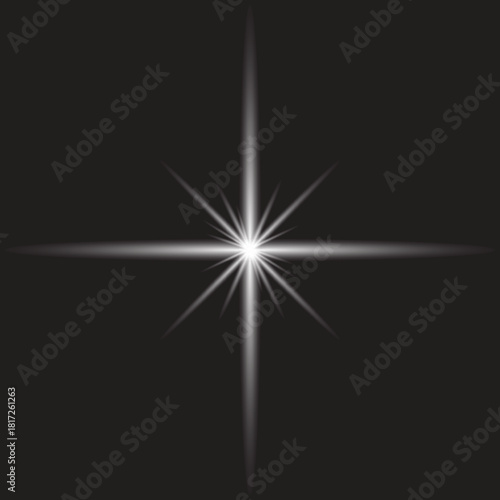 Bright starburst with long rays on a dark background