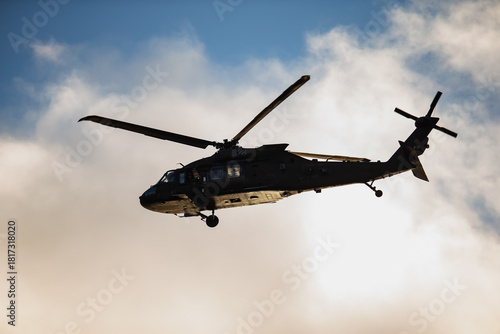 Fototapeta Armed forces helicopter showing tactical fuselage, dual rotor system and underbe