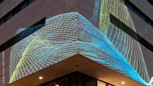 Closeup medium view of a building exterior with programmable projection lighting casting intricate designs and animations creating a captivating visual display.