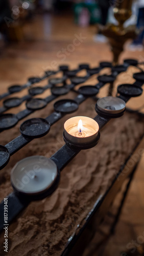 Lit Tealight Candle in Church Votive Holder