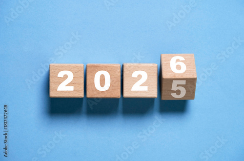 Wooden block flipping from 2025 to 2026 symbolizing beginnings future planning goal setting progress and business development for merry Christmas and happy new year preparation concept.