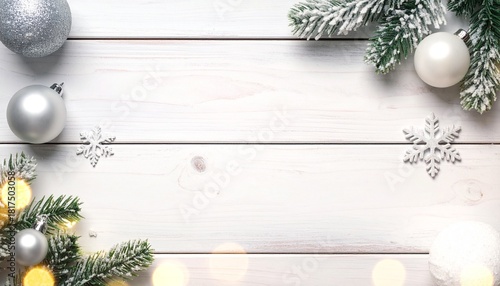 White wooden background with frosted pine branches, silver and white Christmas ornaments, and sparkling snowflakes, creating a festive holiday frame.