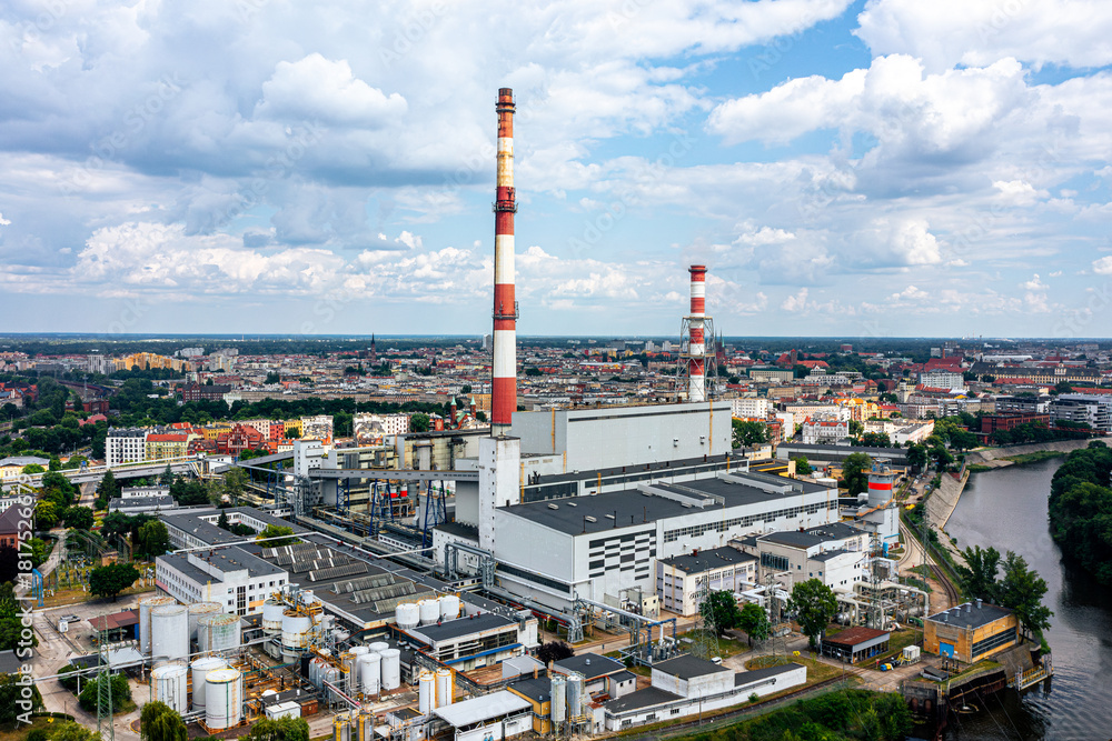 Obraz premium Thermal power plant in the city center against the blue sky. Large chimneys in the city center