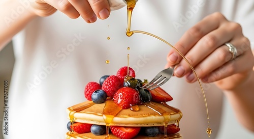 Pancakes extravagance with dripping syrup and fresh summer berries