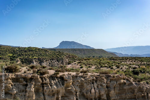 Tabernas desert showing arid landscape with mountains and eroded canyons under clear sky in Andalusia, Spain