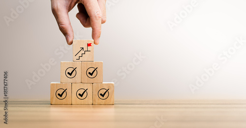 Obraz na płótnie Business growth and success concept with hand placing wooden blocks showing check marks, upward progress symbol
