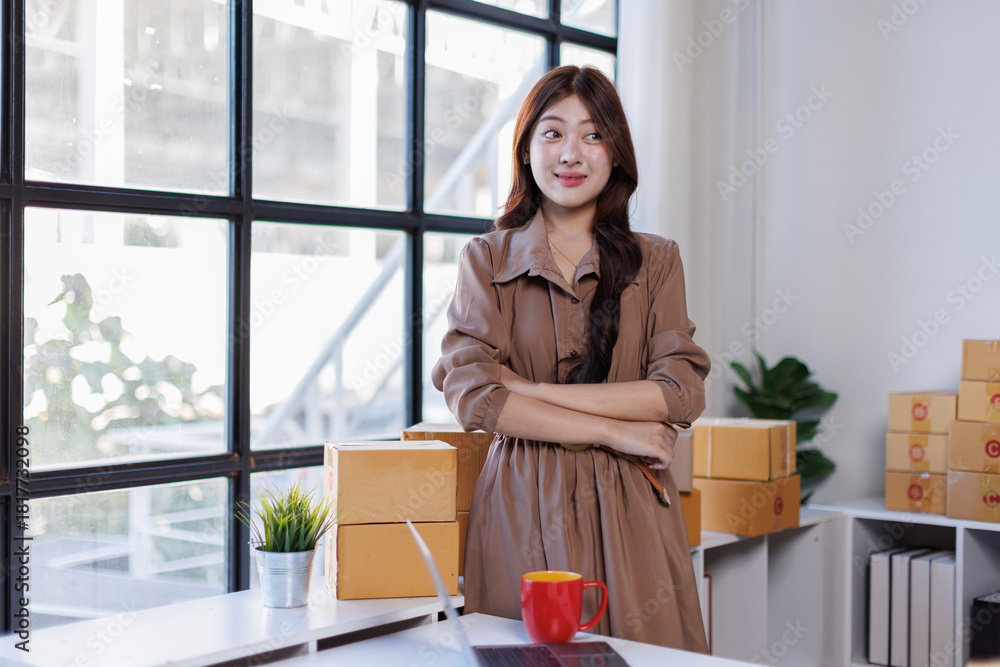 Fototapeta premium Portrait of a Small Business Startup, SME Owner, Female Entrepreneur work on parcel boxes Receipts and check orders online to prepare boxes. Selling to customers. Online SME business idea.