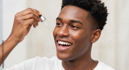Young man applying facial serum for glowing skin