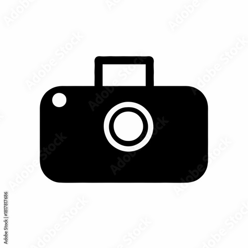 A simple black and white camera icon with a lens, flash, and handle on a white background view