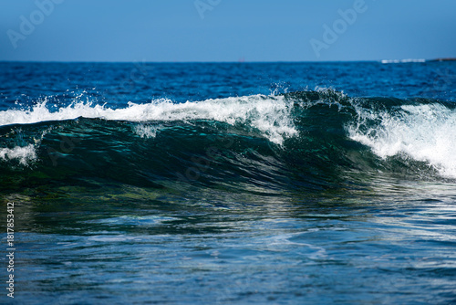Fototapeta Naklejka Na Ścianę i Meble -  Day light on moving sea waves background . Sea waves break and sparkle in sunlight. Blue sea waves shimmer in summer brightness. Waves splash. Sea wave an ocean texture.