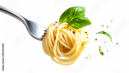 Spaghetti twirled on a fork with basil leaves and pepper.