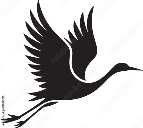 Silhouette of a crane bird in flight with wings spread wide