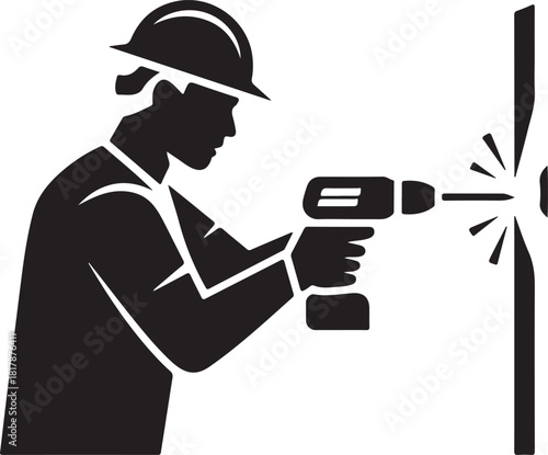 Construction worker in hard hat drilling a hole in a wall