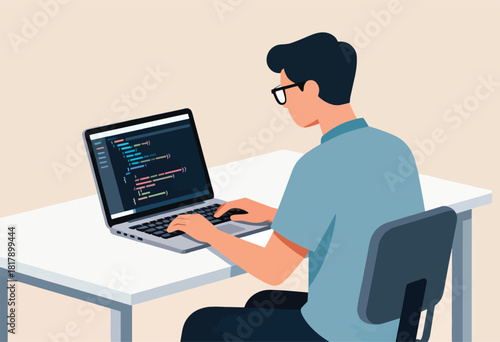 A person with glasses types code on a laptop, at a desk. The code is shown on the screen