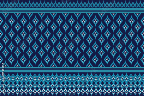 A rich navy blue textile pattern with a central field of repeating light blue diamond shapes, bordered by clean blue stripes and a complex geometric band of teal diamonds and scallops.