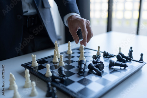 Businessman playing chess business strategy concept