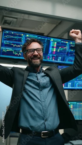 Stock Trader's Victory: A jubilant trader celebrates success in front of a array of monitors displaying stock market data, capturing the essence of triumph and financial achievement.