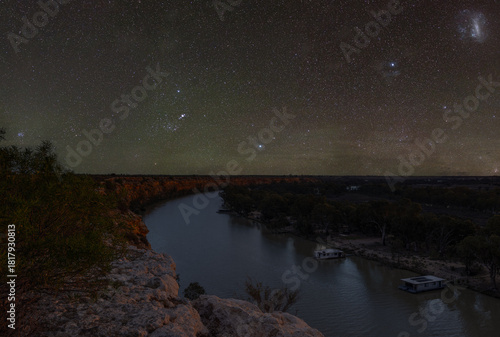 Golden afternoon light illuminates the dramatic limestone cliffs of Big Bend along the River Murray near Swan Reach, South Australia.