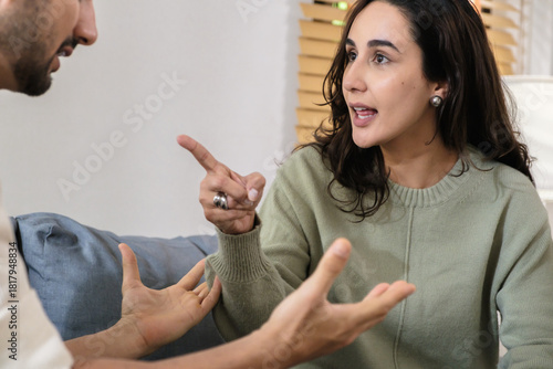 Married couple in emotional conflict and argument at home, fighting through relationship problems and difficult divorce discussions