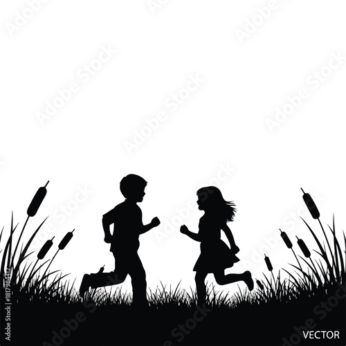Silhouette of two young children running joyfully through tall grass and reeds in a natural outdoor setting