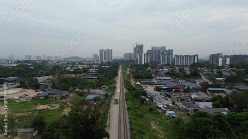 High-angle view showing development and construction near a rail line, illustrating rapid urban expansion.