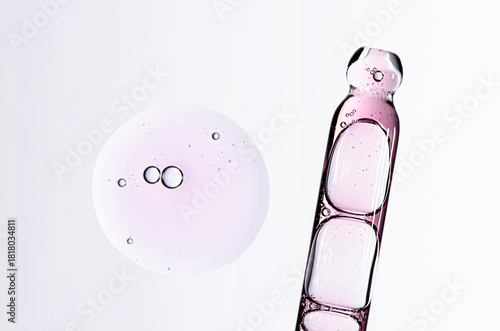 Skin serum in a pipette. A cosmetic product for body care. White background.